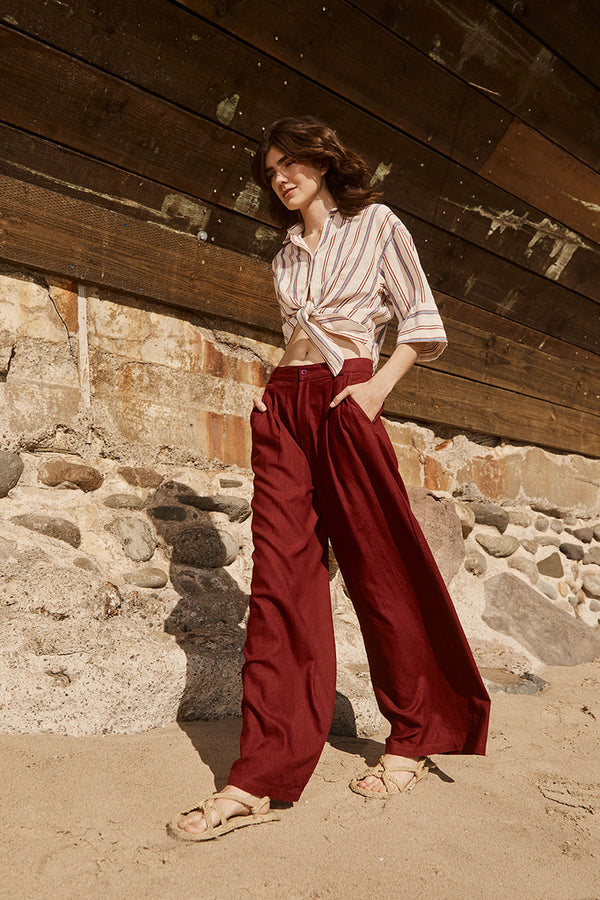 Stateside Linen Wide Leg Trouser in Bordeaux-model is walking and has her hands in her pocket 