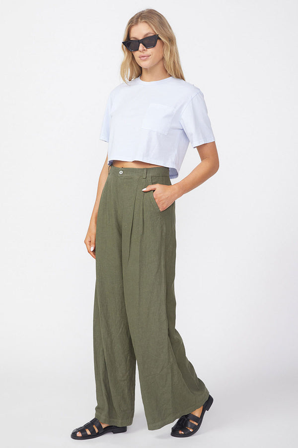 Stateside Linen Wide Leg Trouser in Fern-side view and has her hands her pocket 