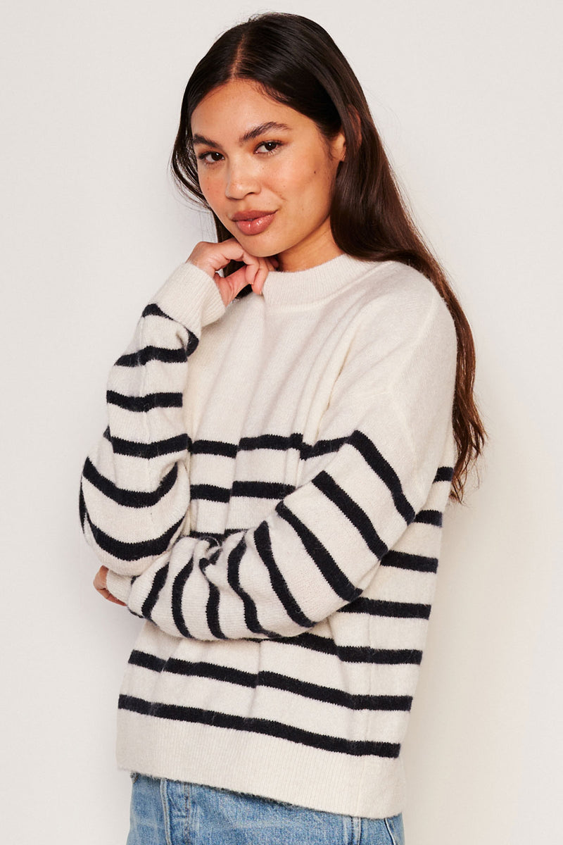 Sundry Stripes Mock Neck Cozy Sweater in Oyster-model has her hand to her face and is smirking 