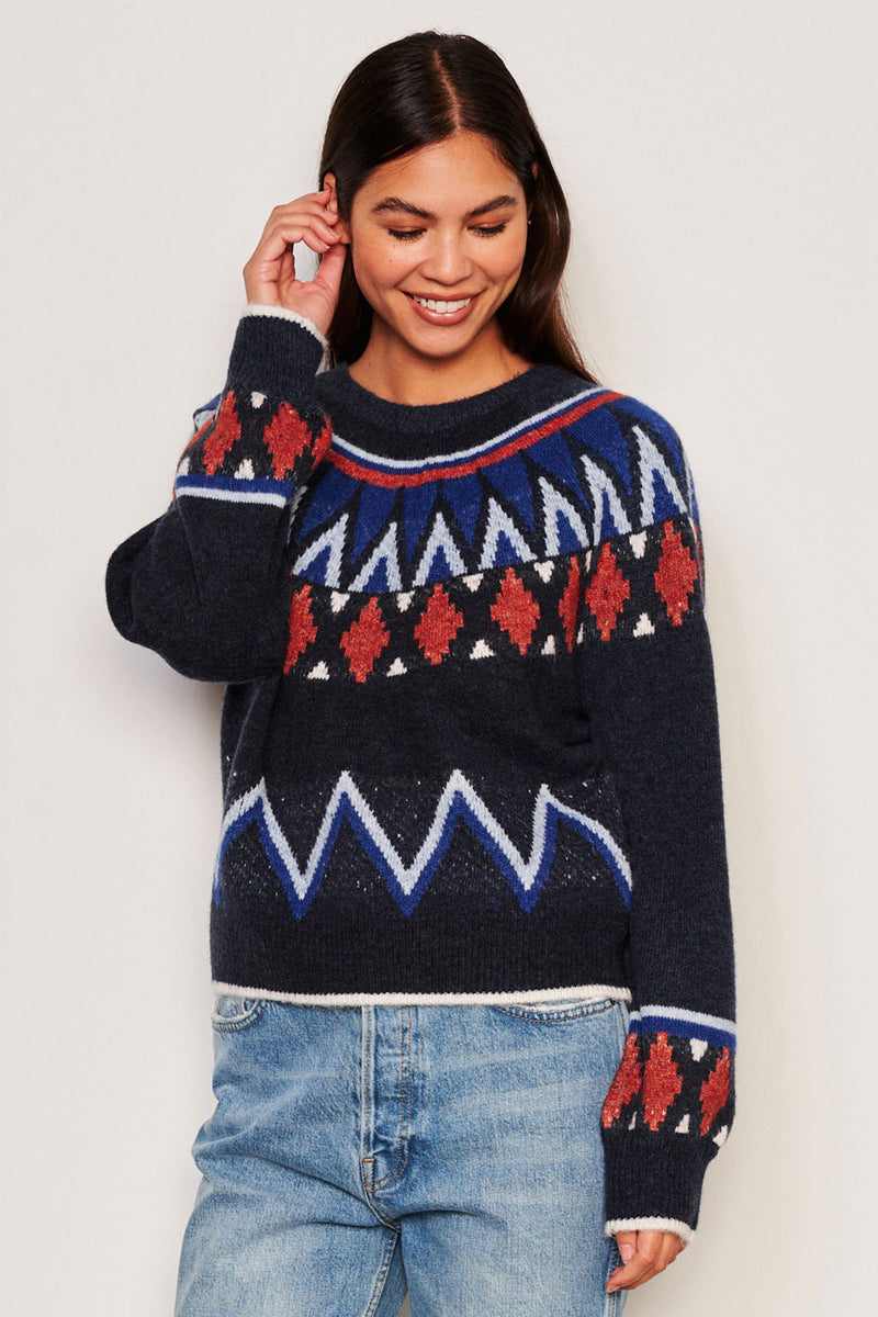 Sundry Fairisle Crew Neck Sweater in Deep Navy -3/4 view model is looking down and has her hair behind her ear while her hand is touching her ear and the other os by her side