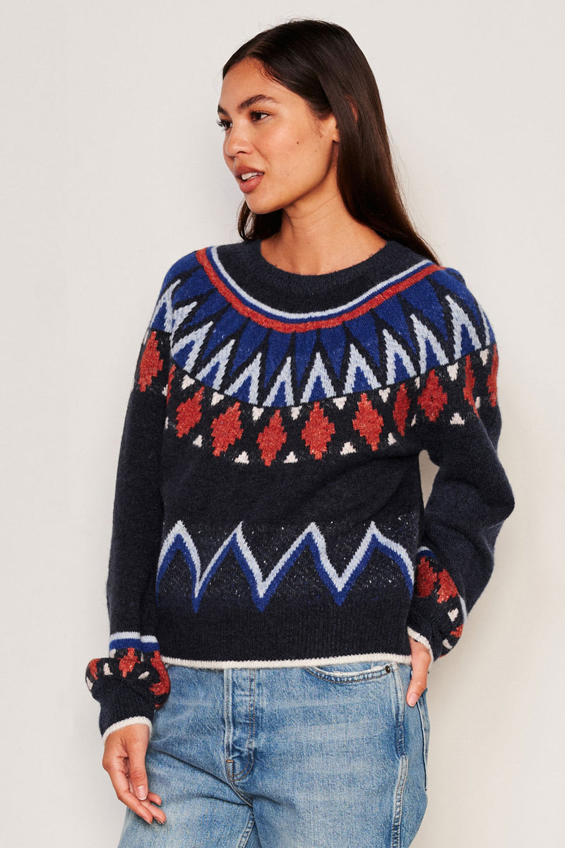 Sundry Fairisle Crew Neck Sweater in Deep Navy-model is looking away and has one hand to her side and the other inside her jean pocket