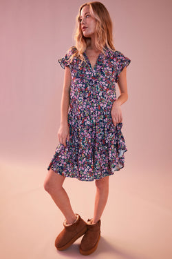 Sundry Mini Field Dress in Deep Navy-model has a ink background model is looking to the side model has her dress lifted 