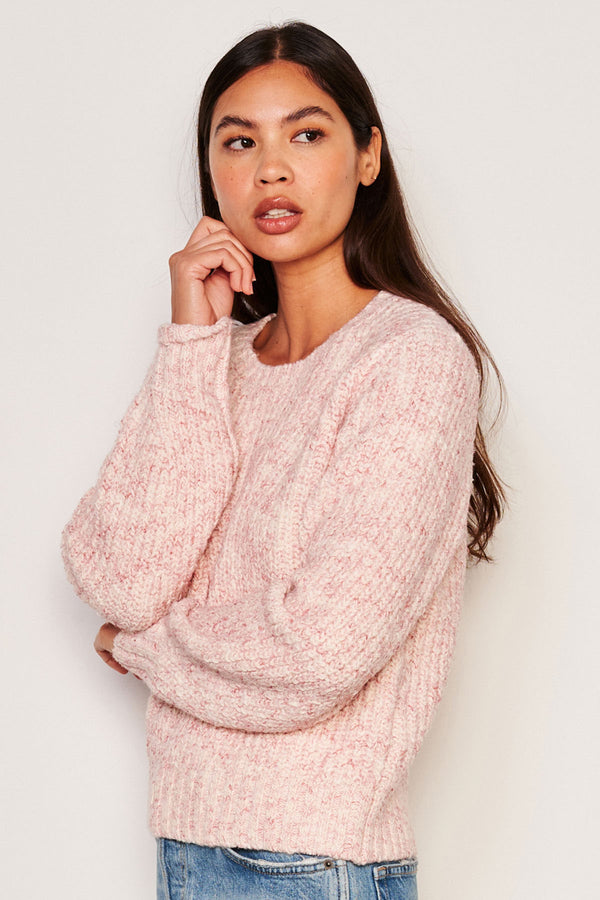 Sundry Rib Transfer Crew Neck Sweater in Guava-model is looking away from camera and has one arm across her waist and the other by her chin