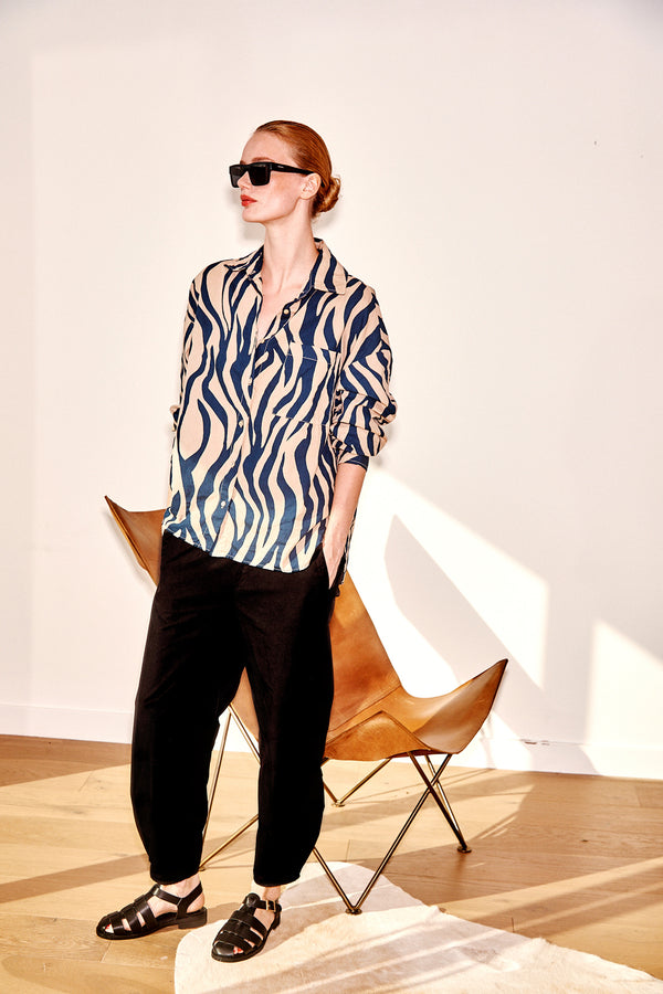 Stateside Zebra Voile Oversized Shirt in Almond-model is standing next to a leather chair 